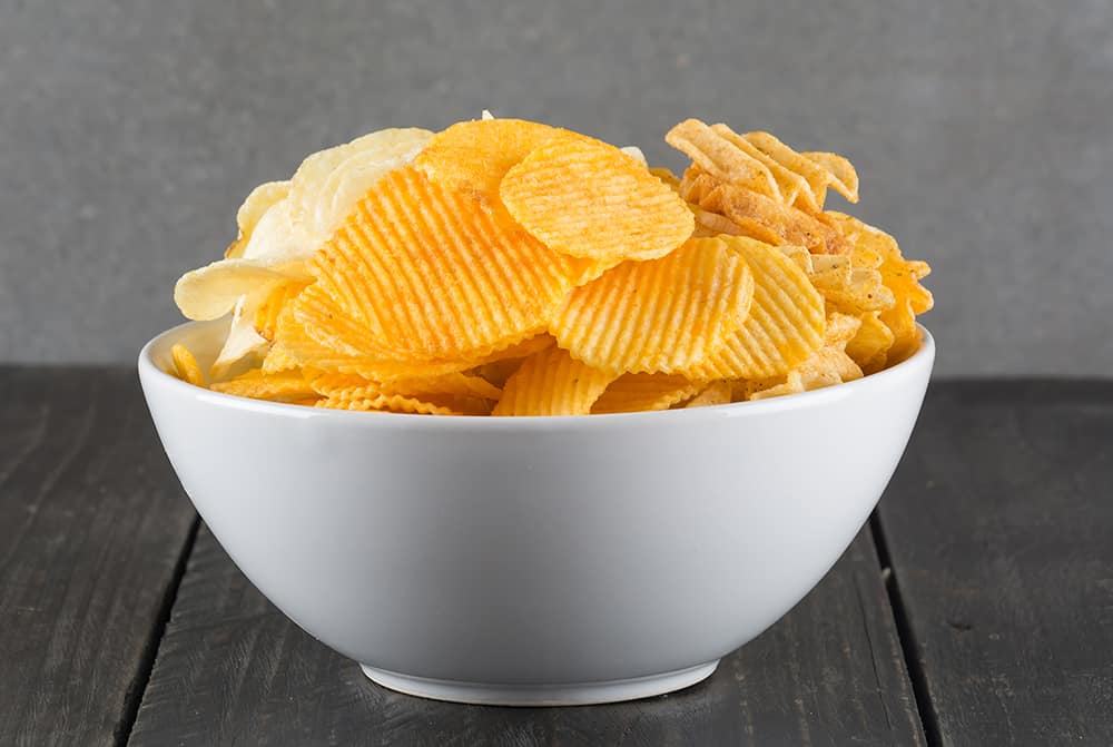 Potato Chips On Wood Background
