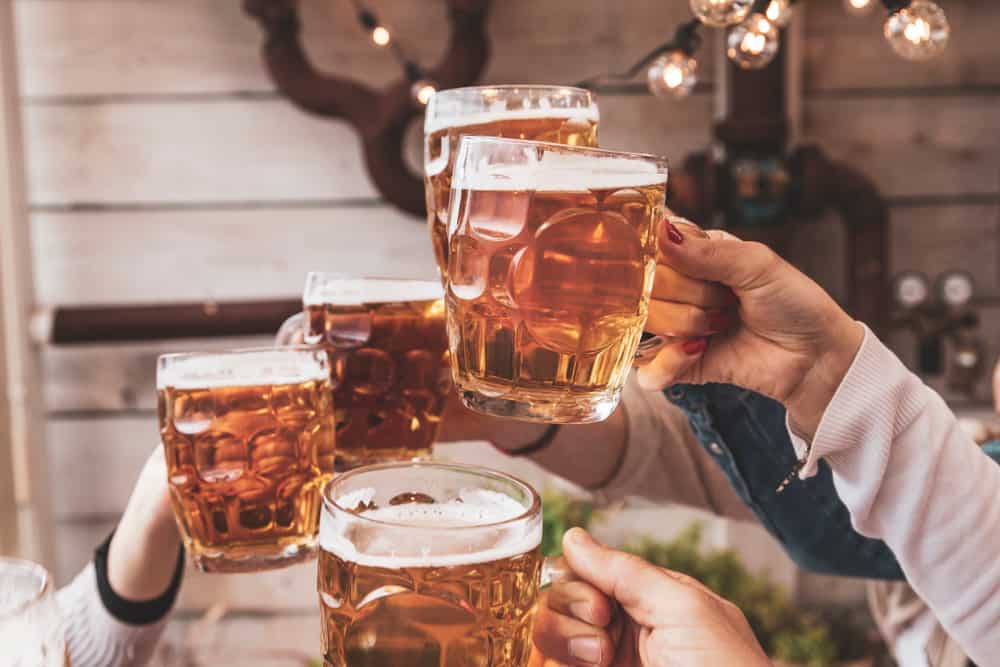 Group,of,happy,friends,drinking,beer,and,eating,take,away