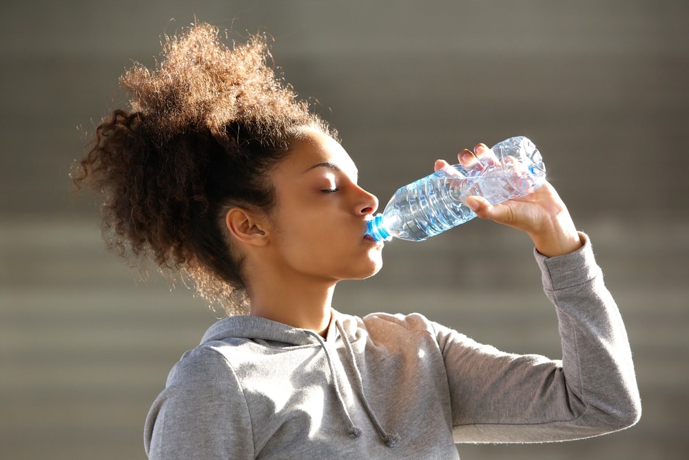 Close,up,portrait,of,an,attractive,young,woman,drinking,water
