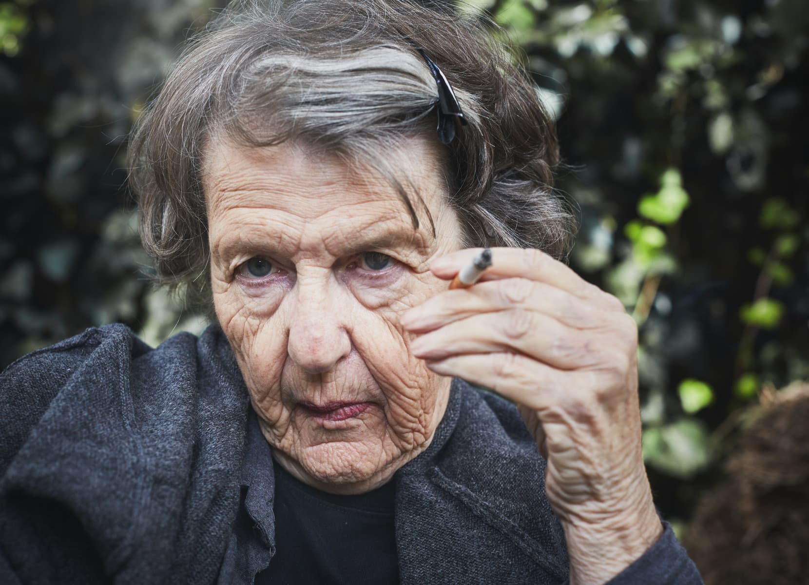 Wrinkled Old Woman Shows Effects Of Smoking
